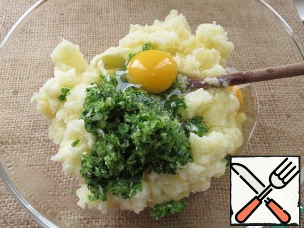 Peel the potatoes, cut into pieces and boil until ready.
Wipe the potatoes with milk and 30 g oil / puree.  Іn a blender chop onions, garlic, herbs.
In puree add eggs, greens, salt and pepper to taste, mix.