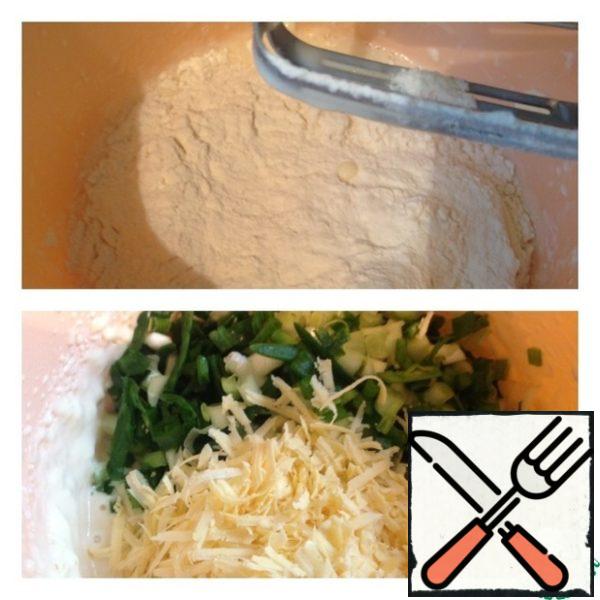 Add the flour and beat again. Onions finely shinkuem, cheese three on a grater, add to the dough and spatula gently and thoroughly mix.