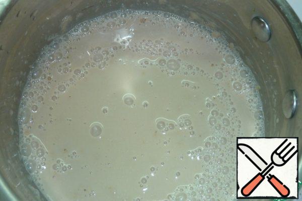 Heat the milk by dissolving the sugar in it. Gradually pour in warm milk and add olive oil.