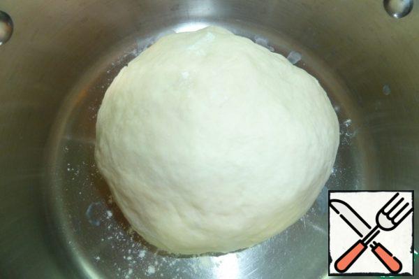 Knead the dough, soft, lagging behind the walls of the dishes. Put the dough in a warm place for 1 hour.