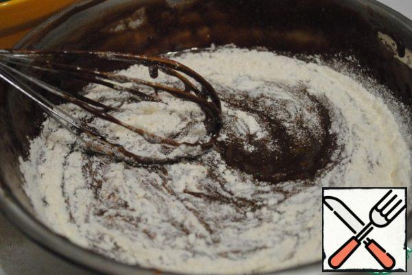 Now pour the chocolate mass into a bowl with beaten eggs, sugar and coffee.
Add flour and whisk until smooth.