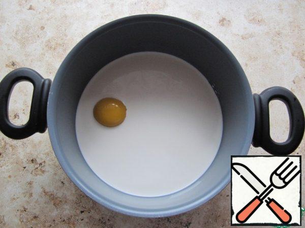 Pour the cream (fat content of 23%) into a saucepan, add the yolk, whisk and cook with constant stirring until thickened (do not boil!).
