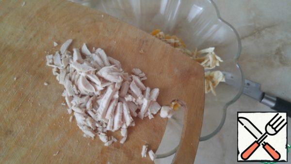 Boil the breast, cut it into small strips.