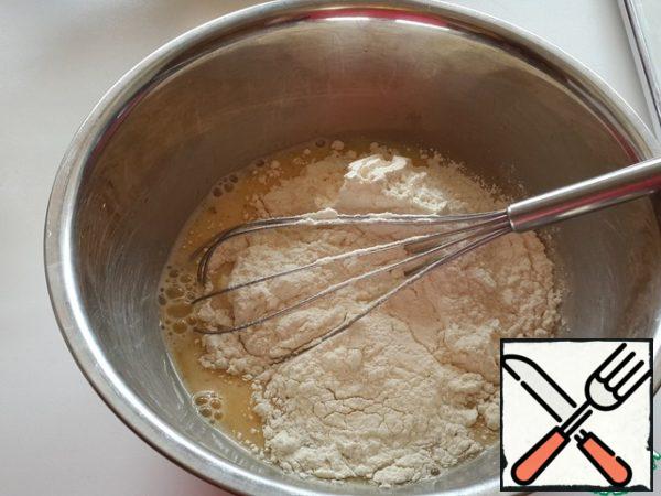 Add flour and baking powder, stir the dough to avoid lumps.