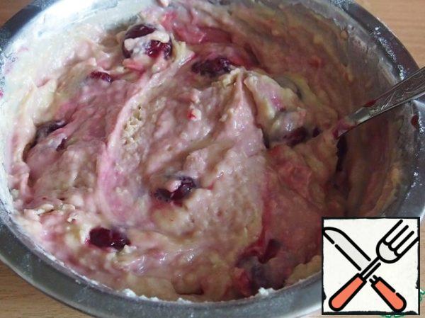 Add flour with baking powder and mix.
Add three quarters of the amount of cherries to the resulting dough, mix gently.
