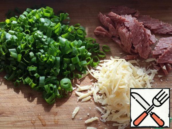 Finely chop the salami and green onions, grate the cheese.