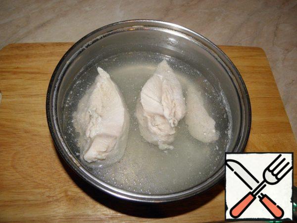 Boil chicken fillet in salted water for 20 minutes, remove from heat, and leave in broth until cool.