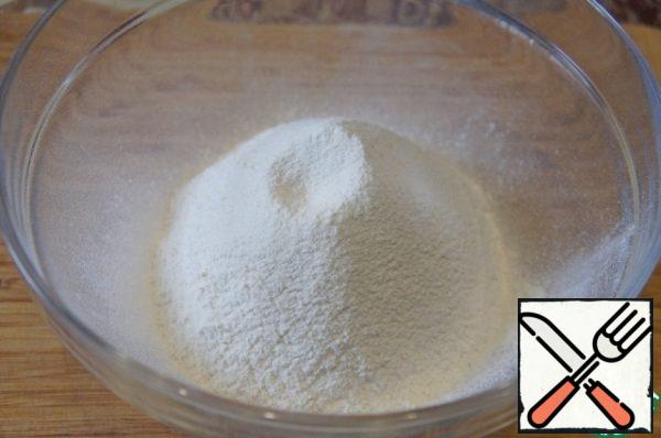 In a deep bowl sift the flour together with baking powder.