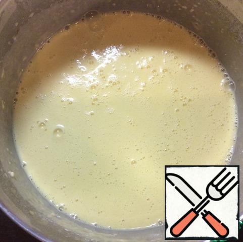 Add the remaining milk. Beat well again. Continuing to whisk, pour the melted butter and vegetable oil.