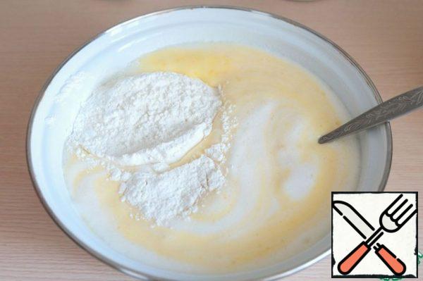 Combine whipped egg white and yolk mass, add flour (1.5 cups) and oil-lemon puree. Mix well.