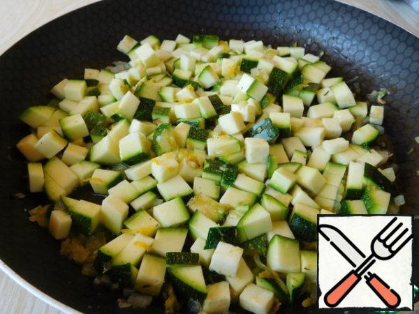 Zucchini cut into small cubes and send to the pan, salt.