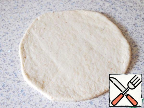 Roll out each piece into a flat cake.
