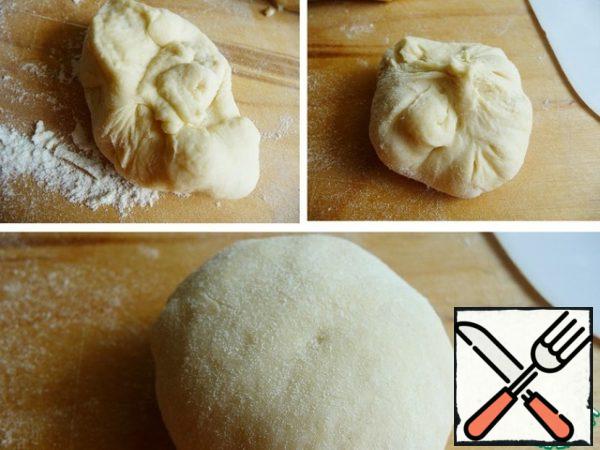 Each piece of dough lightly sprinkle with flour, flatten the cake, squeeze the air to form a ball, pulling the ends of the dough to the center. Turn the workpiece seam down.