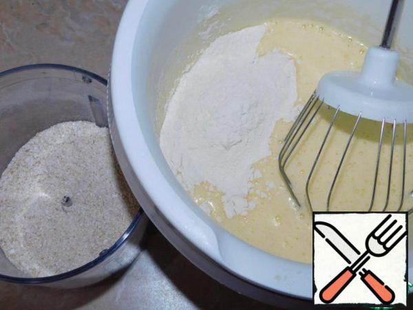 Beat eggs with sugar. Add to them flour, milk, vegetable oil, soda and crushed oat flakes.