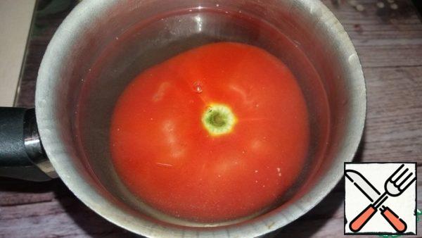 Blanch the tomato and peel it.