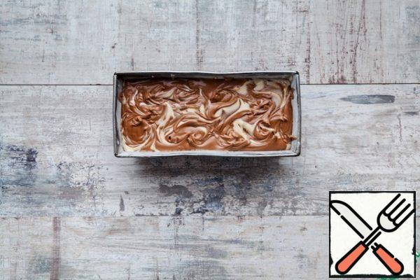 Now pour the white dough into the prepared baking dish. Pour in the white chocolate dough and mix lightly with a chopstick to make "marble" patterns.
