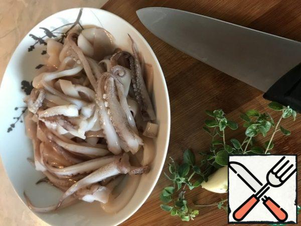 Next - a frying pan, olive oil, fry the garlic slices and put them out of sight. Send the prepared squid to fragrant oil and fry over medium heat!!! 3 minutes, otherwise it will look like a dry sponge!!! Pour the wine and wait until the alcohol has evaporated. Next, we send all this fragrant richness to the tomatoes, taste for salt, if it turned out very sour, add sugar and let it go, closing the lid, on low heat for 10 minutes. At the end, add finely chopped grass.