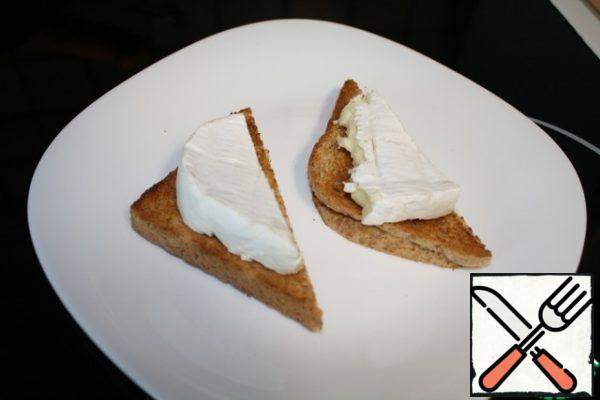 On a piece of white bread, I took bread from the toaster, put a piece of cheese.
