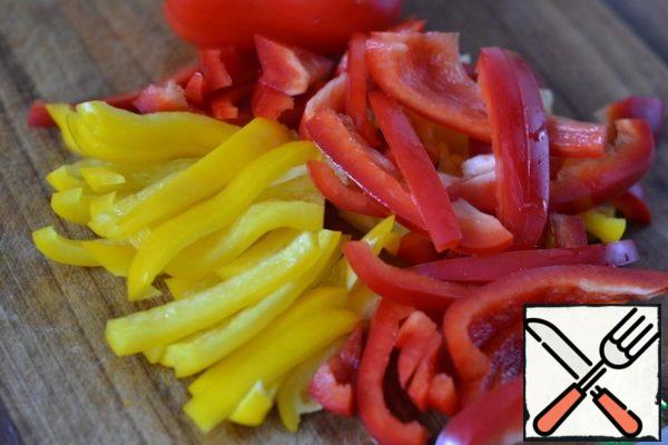 Cut carrots and bell peppers into strips.