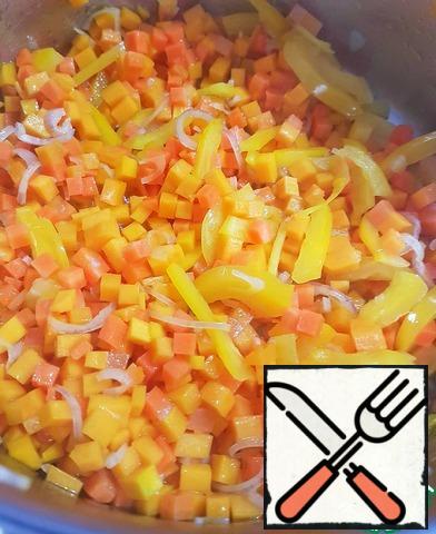 In a saucepan with a thick bottom, heat the vegetable oil. Fry the chopped vegetables for about 2-3 minutes, stirring constantly.