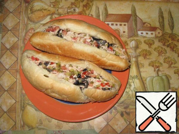 Cut the hot dog buns in half, but not completely. Remove the crumb and fill with the filling. Here are such cute buns turned out!
