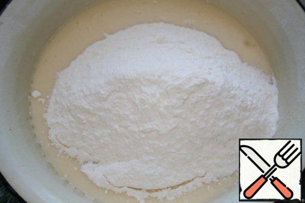 Add the sifted flour with baking powder.