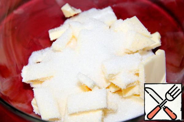 Turn on the oven at 180 degrees. Cut the butter into small pieces and add sugar.