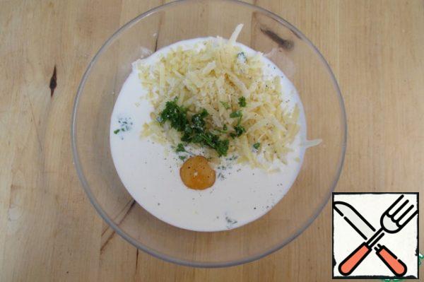 Meanwhile, mix the milk, cream, grated cheese, eggs, and a little chopped parsley. Add salt and pepper to taste.

