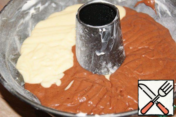 Form with a tube (26 cm in diameter) carefully lubricate with margarine (each hem) and sprinkle with flour, turn over and easily knock the edge to remove excess flour. Place in the form of the white part of the dough, and the top chocolate.