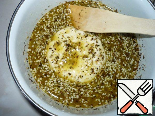 Each cake is dipped in butter with herbs and sesame seeds.