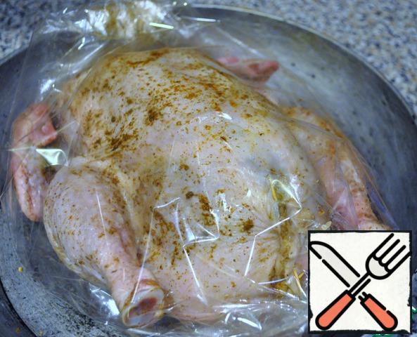 Place the chicken in a baking sleeve. Staple the edges. Put in the oven for 1 hour 10 minutes at a temperature of 200 degrees.