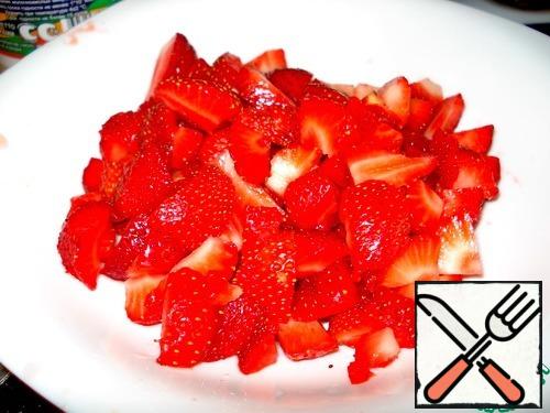 Cut strawberries into pieces.