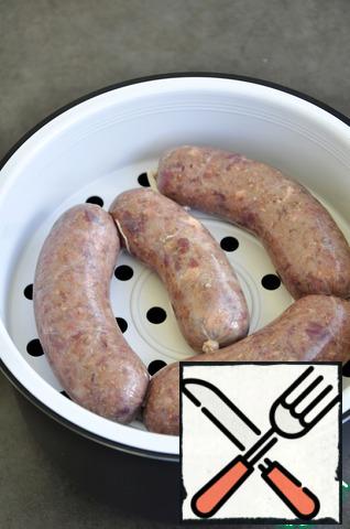 Option 1)
In the bowl slow cooker pour water, put the bowl steamer, put it in sausages. Cook with boiling water for 15 minutes.
