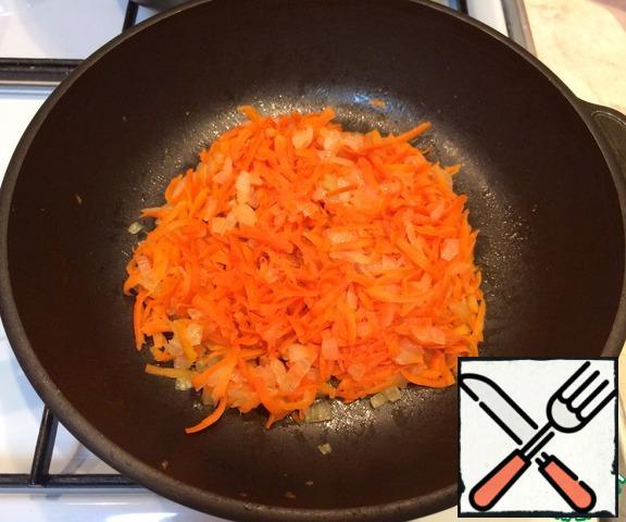 Add the grated carrot to the onion and fry for 5 minutes.