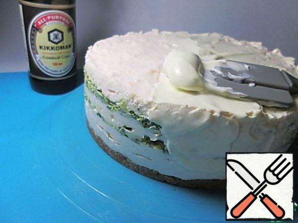 The finished cake to be derived from the shape and coat it with a thick sour cream. If desired, you can add a little green food dye to the sour cream or mix with chopped herbs.