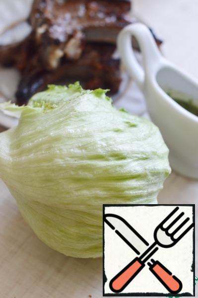 Marinated meat is grilled, can be baked in the oven or fried in a frying pan.
Break iceberg lettuce with your hands.