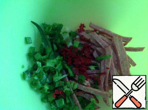 Chop the onion, cut the sausage into thin cubes. Peel the pepper from the seeds and finely chop.
