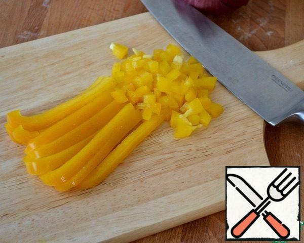 Then cut in half and remove seeds from peppers, cut into strips and also into small cubes. We try to cut all vegetables of the same size.