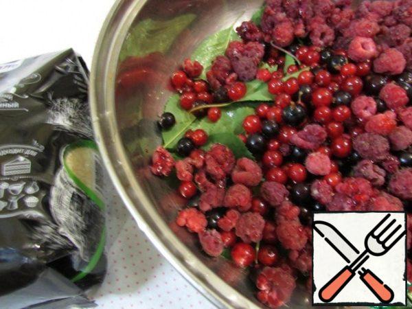 Put the cherry leaves and assorted berries in a saucepan.
