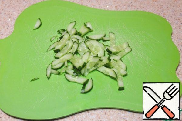 Cut cucumbers into thin strips.