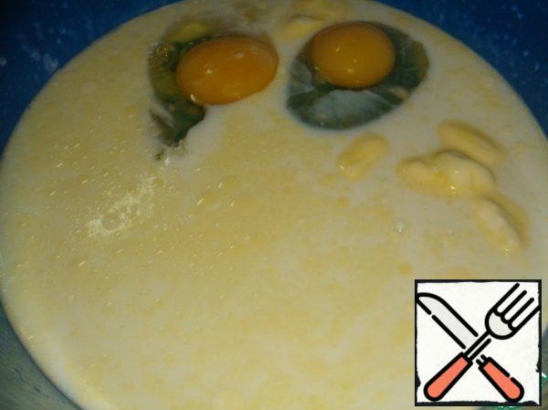 In the rest of the warm milk dissolve remaining sugar, butter, stir.
Add eggs, yeast mixture and mix again.