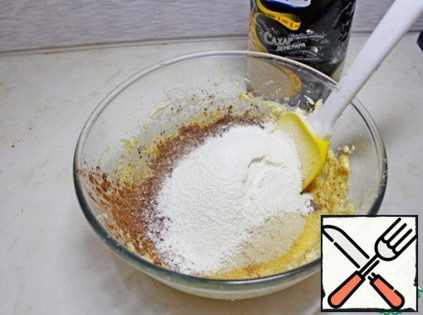 Add the sifted almond and wheat flour, cocoa powder and baking powder to the egg-butter mass.
If you don't have almond flour, you can either just grind the almonds into crumbs. or replace with wheat flour.
Mix it.