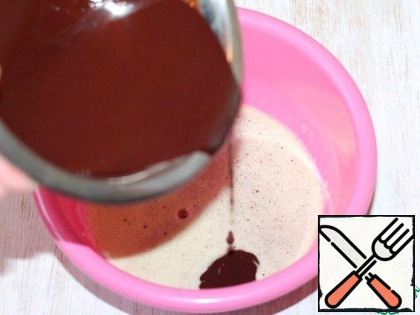 Pour the cooled chocolate mass to the egg mixture and mix.