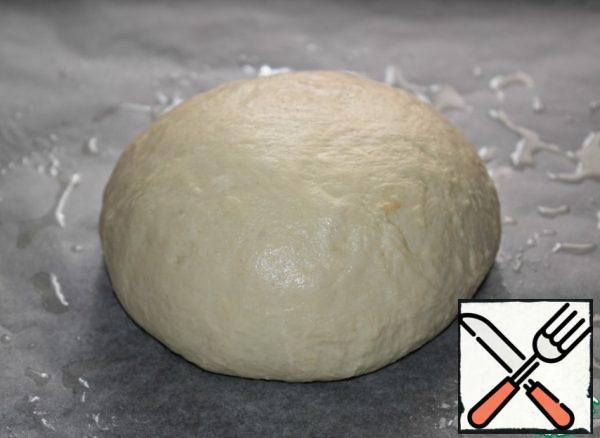 Knead the dough, form a round loaf. Put on a baking sheet covered with baking paper (grease the paper with vegetable oil). Cover with linen towel and put the baking tray in a warm place for 25-30 minutes. 