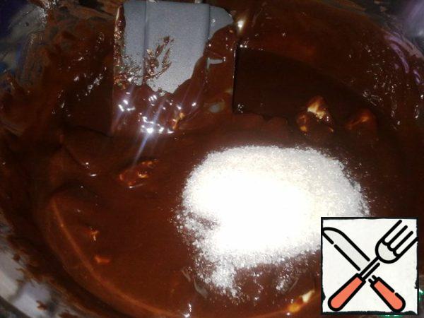 Add sugar, mix well, remove the container from the water bath and cool slightly.
