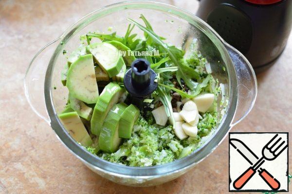 Add chopped garlic, arugula, avocado, peppers, grind again;