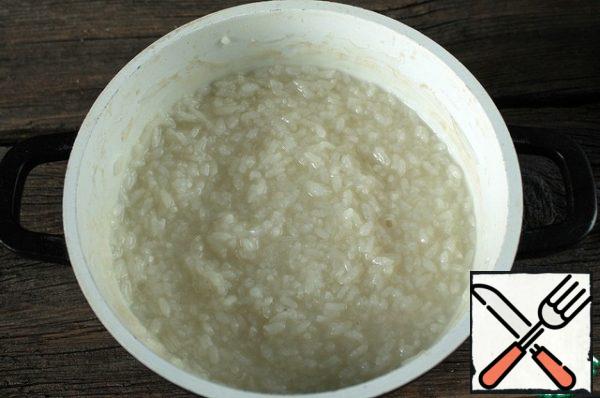 Wash rice, cover with water and cook on medium heat until tender, better even longer, until the rice begins to soft after boiling. The rice is supposed to be liquid, but starchy.
Choose round rice for porridge, it is best boiled to the desired consistency!