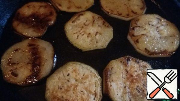 Cut the middle of the eggplant into slices and fry in vegetable oil. In the process roasting to put salt on with 2- ' s sides. Put on paper towels to get rid of excess oil. Cut the tips of the eggplant into small oblong pieces and fry too.