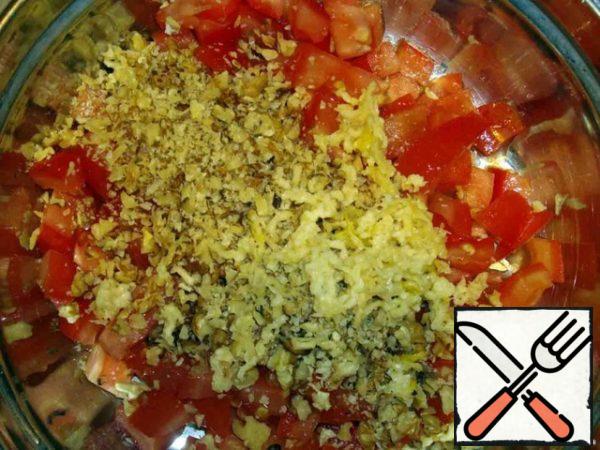 Add the chopped nuts and garlic to the tomatoes.