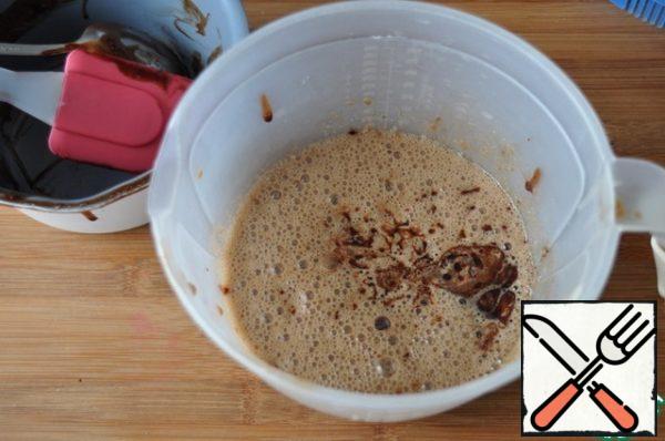 Add the slightly cooled chocolate-butter mixture. Mix it.